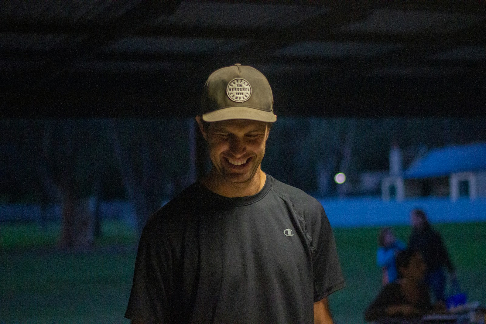 man in black crew neck t-shirt and gray fitted cap