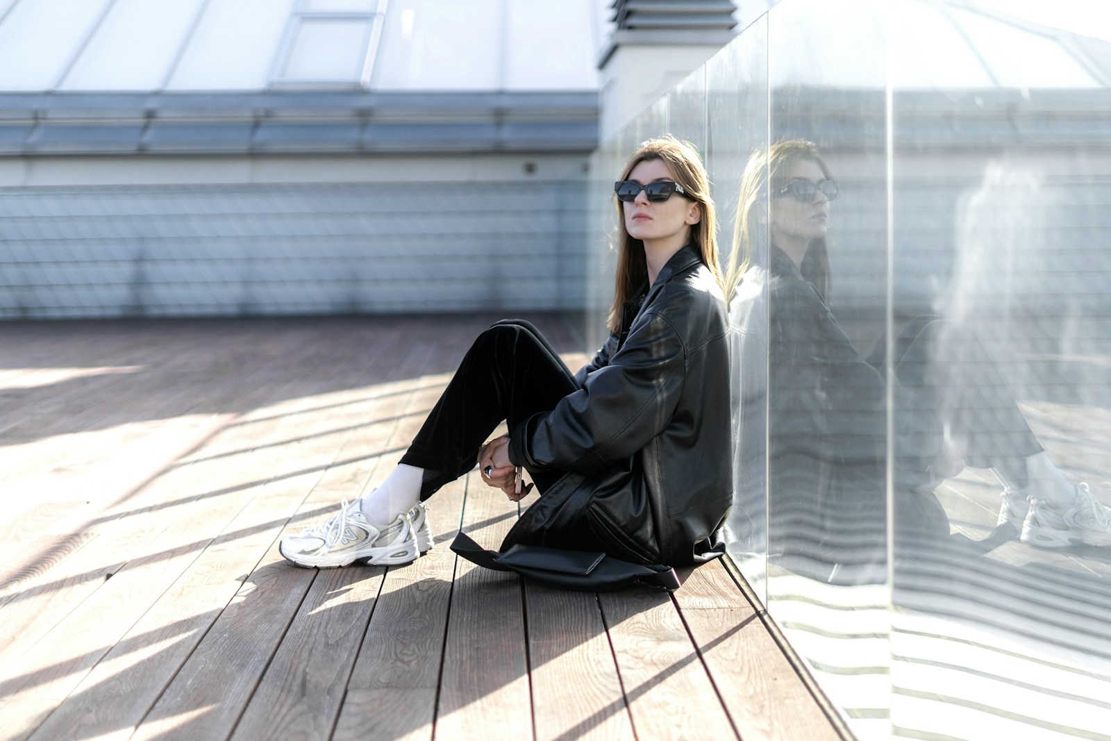 a woman sitting on top of a wooden floor