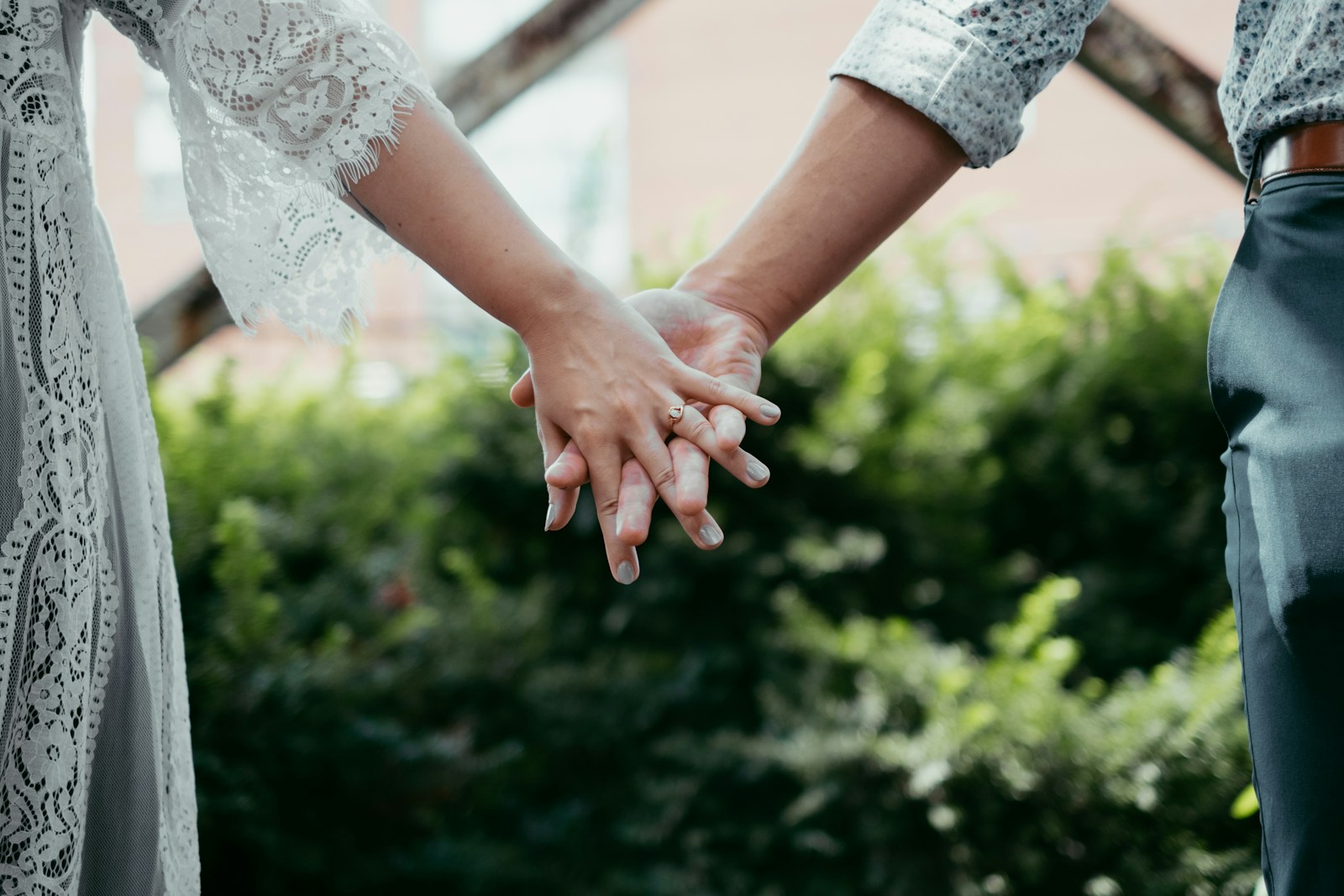 woman in white lace shirt holding her hands