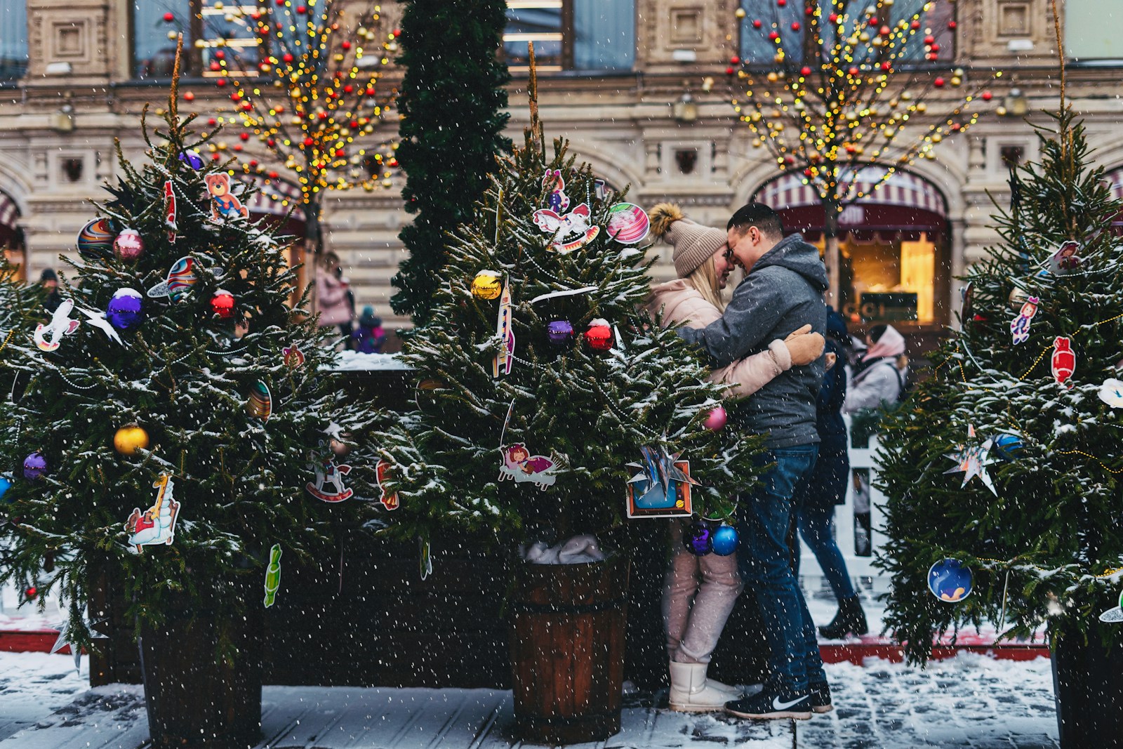 couple near Christmas trees on street