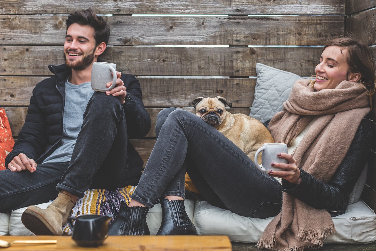 merry christmas, man, woman, dog, animal, pet, pug, owners, couple, relationship, warm clothes, cozy, scarf, jackets, jeans, boots, fashion, people, happy, love, female, young, male, adult, caucasian, happiness, romantic, portrait, smile, smiling, girlfriend, date, boyfriend, together, person, lovers, sitting, relaxing, rustic, cushions, couch, laughing, enjoying, coffee